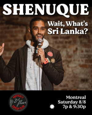 A comedian performing in front of brick wall.
